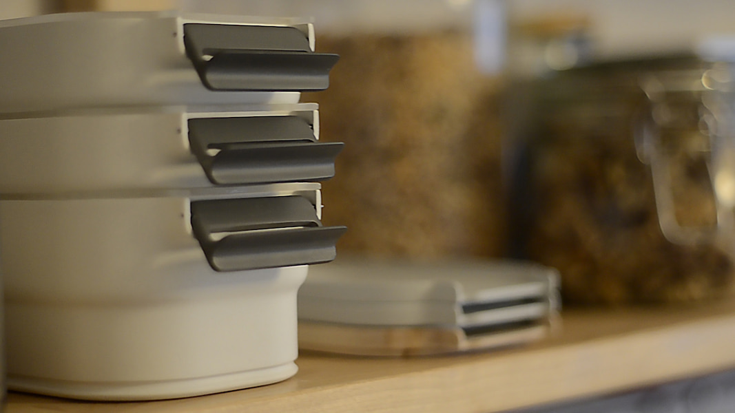 stacked lunchboxes in cupboard